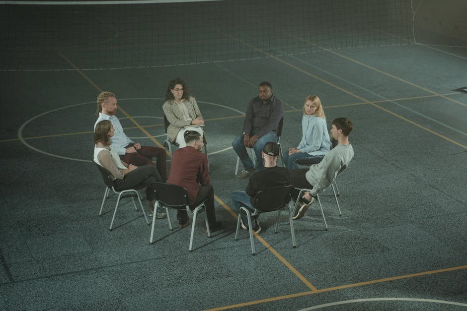 Group therapy circle on an inpatient psychiatric unit with whiteboard listing DBT skills