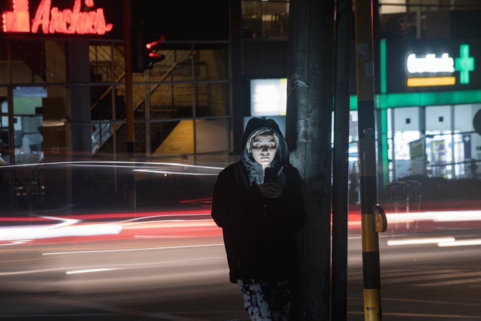 Person on a phone in distress at night under streetlight illustrating a gambling addiction crisis