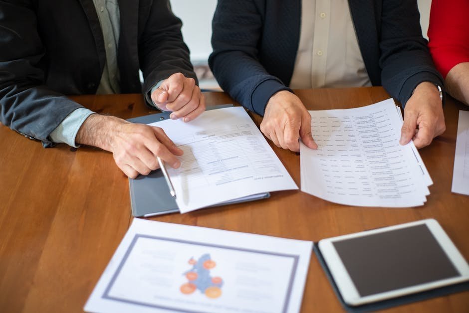 Geriatric care manager reviewing benefits paperwork with elderly woman