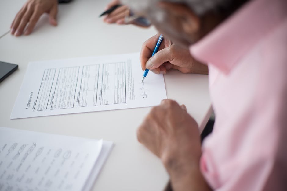 Life insurance application paperwork and a pen