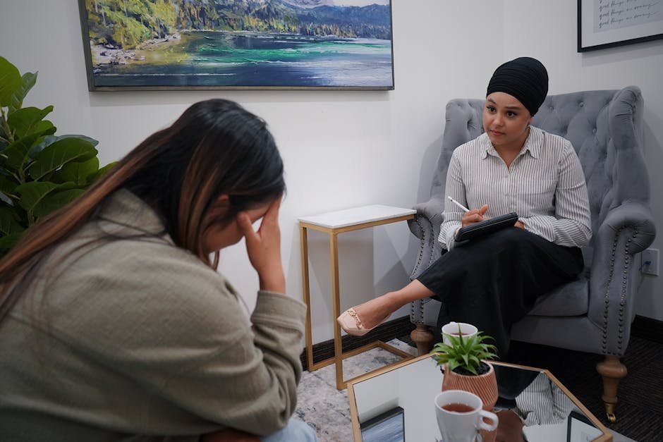 Latina woman in therapy session with bilingual therapist taking notes