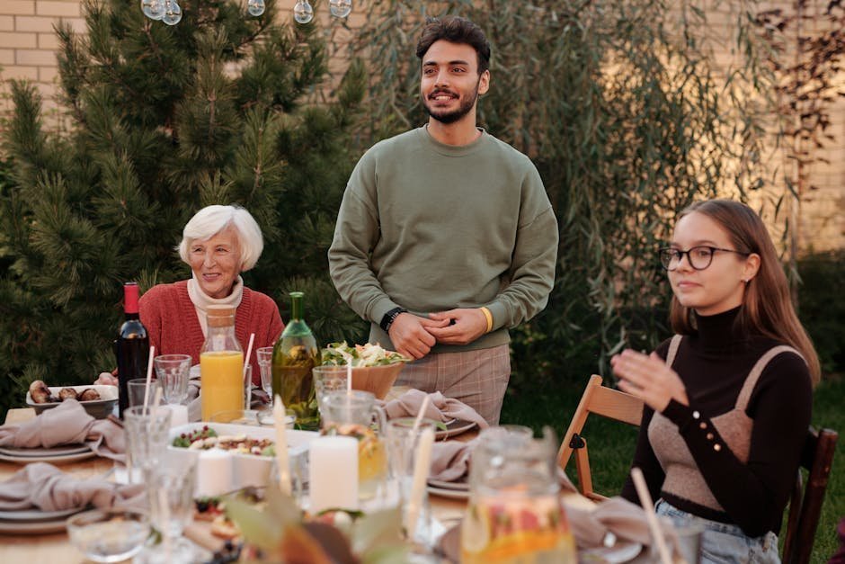 Multigenerational family at outdoor table sharing meal, representing money attitudes passed across generations