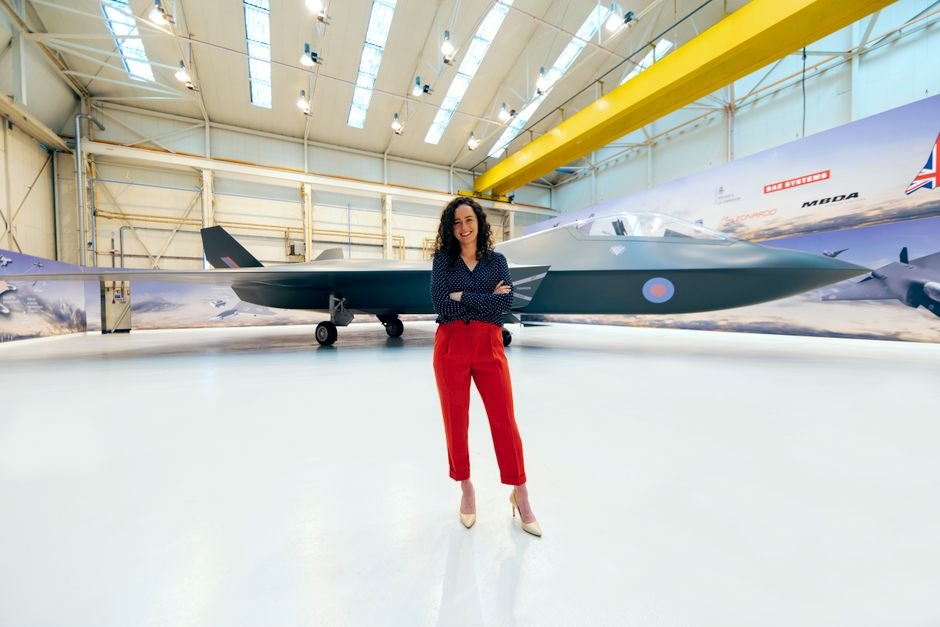 An aerospace engineer standing in front of an aircraft