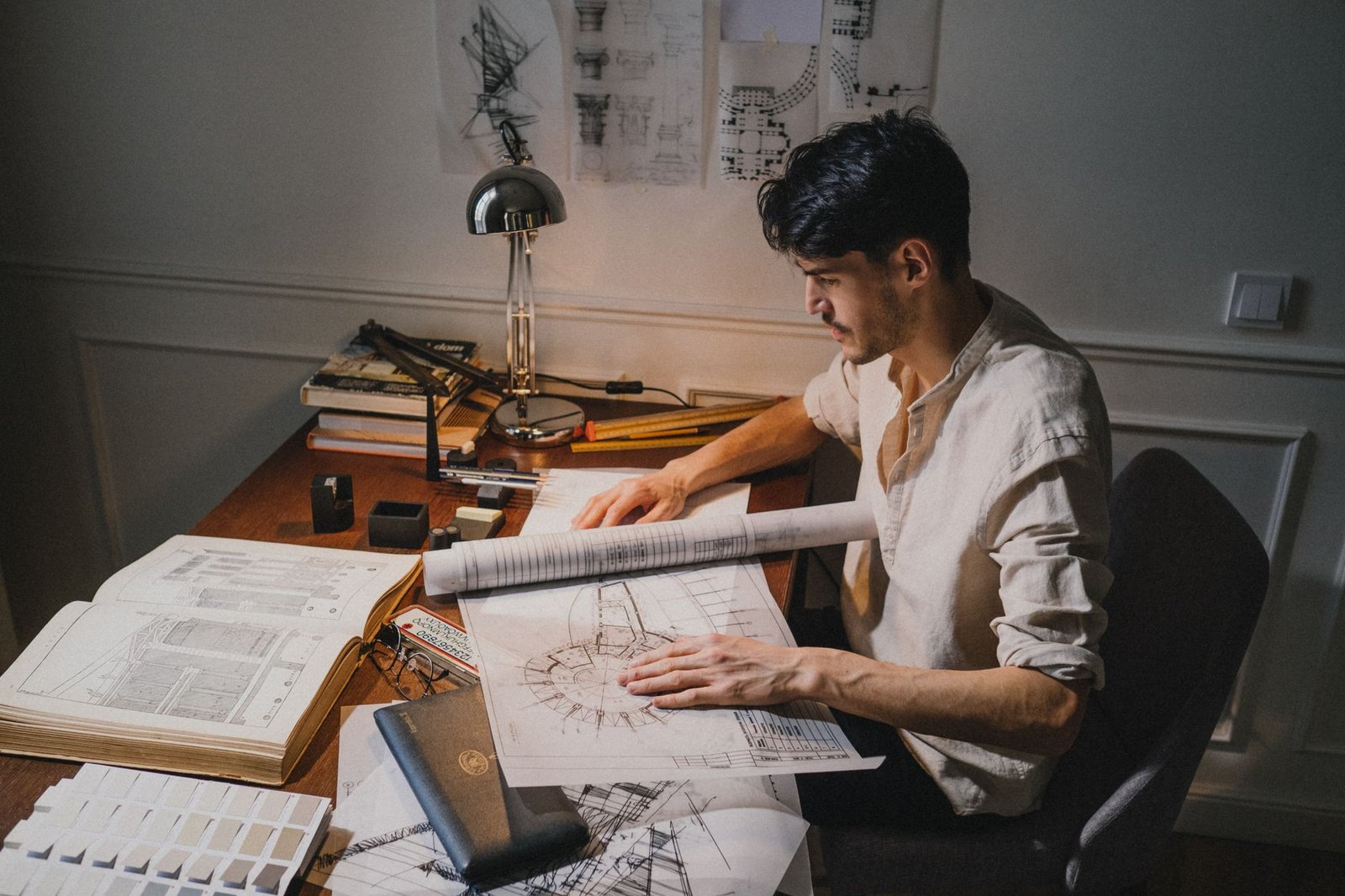 Architect reviewing blueprints, a core skill taught at top architecture universities